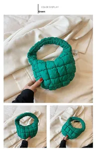 Close-up of green quilted cloud bag featuring pleated handles and soft textured finish