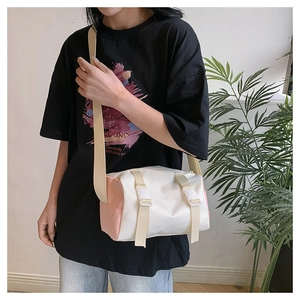 Close-up of a white and pink minimalist crossbody bag with durable buckle straps