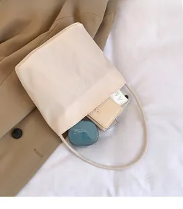 Detail view of cream nylon tote bag interior showing spacious storage for daily items