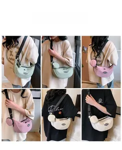 Detail showing the adjustable wide woven strap and matching coin purse on nylon crossbody bags