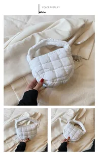Detail view of a white quilted cloud bag with puffy grid texture and handle