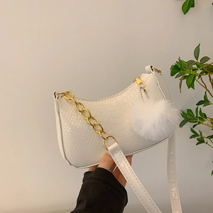 White faux leather crescent shoulder bag with crocodile texture and gold chain strap