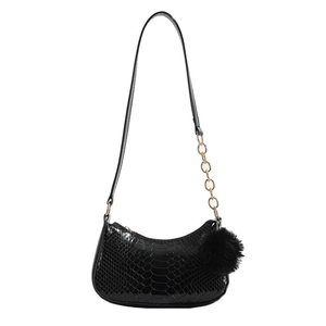 Glossy black crescent shoulder bag with crocodile texture, gold chain and plush charm