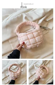Detail of pink quilted puffer cloud bag with soft padded handle and silver zipper closure