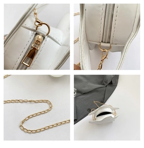 Détails rapprochés du sac étoile en cuir verni blanc avec chaîne dorée et fermeture