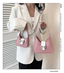 Detail of pink and white saddle bag set with a silver metallic bow decoration