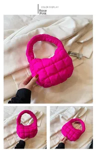 Detailed view of the quilted texture and puffy handle of the rose pink cloud handbag