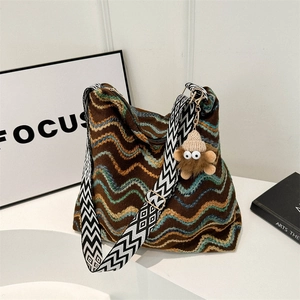 Retro knit tote bag with colorful wave patterns and a wide geometric shoulder strap