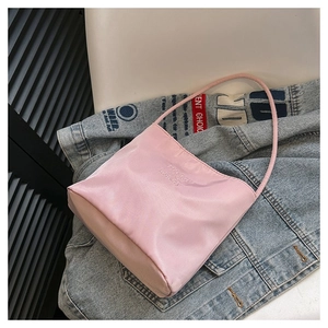 Pink nylon tote bag with 'pretty and liberty' embroidery on casual denim jacket