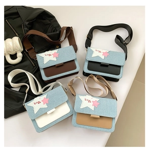 Detail of four denim patchwork shoulder bags with star patches in coffee, black, and white