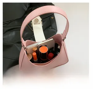 Pink leather hobo saddle bag showing interior capacity for phone and cosmetics