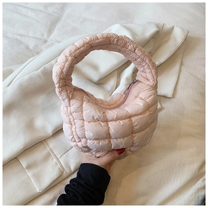 Detailed close-up of pink quilted cloud bag featuring soft padded texture and smooth zipper