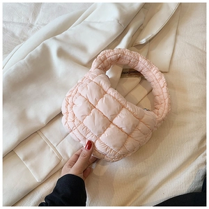Detail of light pink quilted cloud bag with KIMHĒKIM inner label and soft padded handle