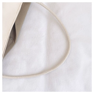 Close-up of beige leather shoulder bag showing neat stitching and fine material texture