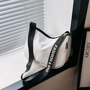 Minimalist white canvas shoulder bag with adjustable fashion strap for travel and commute