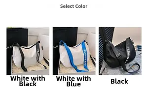 Detail view of nylon crescent bags in white, blue, and black with adjustable straps