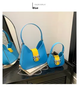 Detail view of blue saddle bags featuring yellow leather straps and silver bow buckle