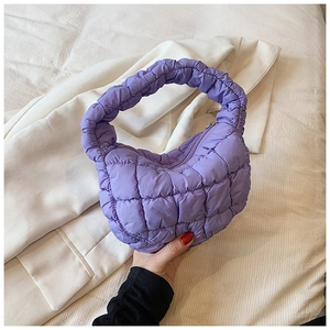 Detailed close-up of purple quilted cloud bag showing soft fabric texture and stitching
