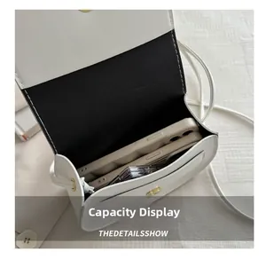 Interior view showing the capacity of a white crossbody bag with a smartphone inside