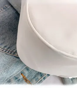Detail view of lightweight white canvas bag showing fine textured fabric and clean stitching