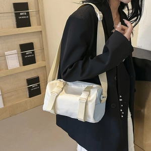 Chic two-tone cylindrical crossbody bag in beige and blue with a wide shoulder strap