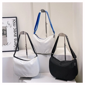 Detail view of crescent nylon shoulder bags with adjustable wide fashion letter straps