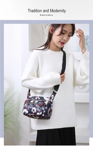 Detail of floral nylon crossbody bag with multi-zipper pockets and adjustable strap