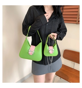 Fruit green saddle shoulder bag and mini chain purse with metallic pink bow detail