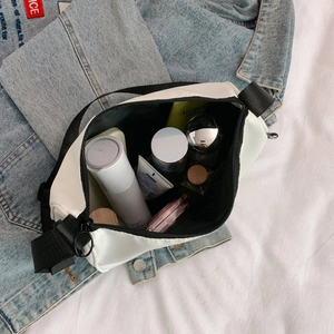 Top view of the spacious white crossbody bag showing inner storage with cosmetics
