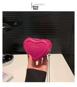 Detailed macro shot of the rose red heart-shaped PU leather crossbody bag with chain