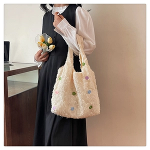 Detailed view of plush off-white tote bag with colorful floral dots and soft texture