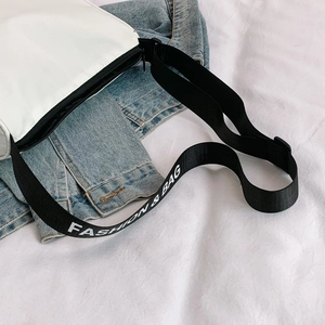 Detail of canvas bag featuring fashion strap and high-quality black metal zipper closure