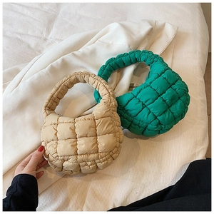 Detailed top view of beige and green quilted bubble cloud bags with soft padded texture