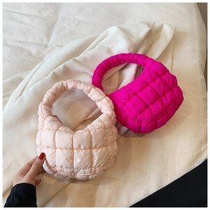 Detail of pink and fuchsia quilted cloud handbags with textured puffer material