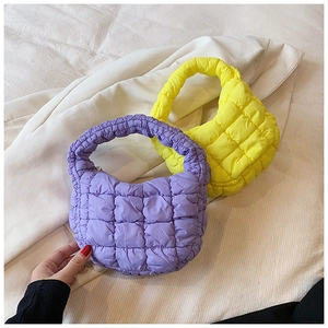 Detailed macro of quilted bubble cloud mini bags in purple and yellow nylon fabric