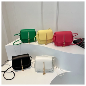 Detailed collection of colorful crossbody bags with fringe and gold metal buckle on stands