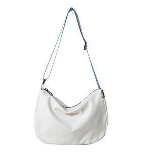 White half-moon canvas crossbody bag with blue adjustable shoulder strap and fashion label
