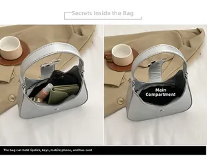 Internal storage view of silver metallic crescent bag showing phone and lipstick capacity