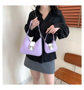 Detailed comparison of lavender leather saddle bag and mini pouch with silver bow
