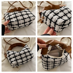 Detail view of plaid tweed handbag with leather handles and interior zipper compartment