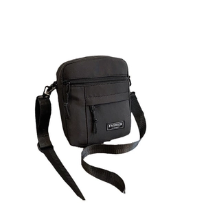Vertical black nylon crossbody mini bag with adjustable strap and fashion label detail