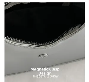 Detail of grey leather handbag showing the secure silver magnetic closure and zipper