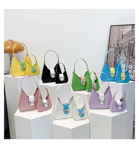 Detail view of bow-decorated contrast saddle bags in various vibrant colors on display