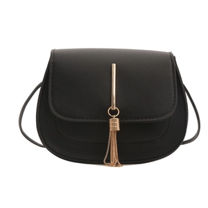 Minimalist black faux leather crossbody saddle bag with gold trim and tassel detail