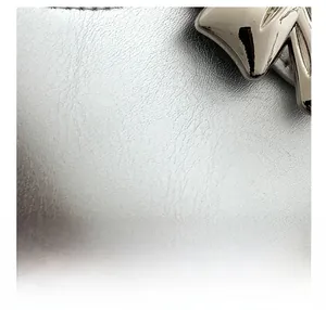 Close-up detail of silver leather texture and polished metal buckle on the crossbody bag