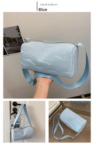 Three-view layout showing light blue cylindrical bag with textured material and shoulder strap