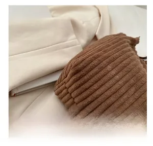 Detailed close-up of dark brown corduroy fabric texture on a large capacity tote bag