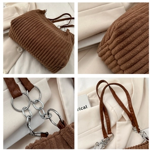 Close-up of brown corduroy tote fabric with leather strap and silver metal hardware details