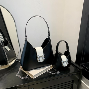 Chic black and white saddle bag set with silver bow buckle and elegant chain strap