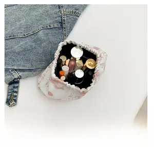 Detail showing high capacity of Chinese style nylon drawstring bag with floral pattern